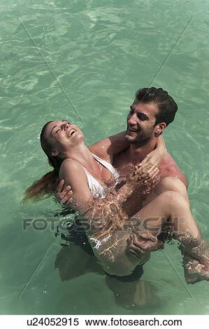 Couple playing in tropical sea View Large Photo Image Stock Photography - Couple playing in tropical sea. Fotosearch