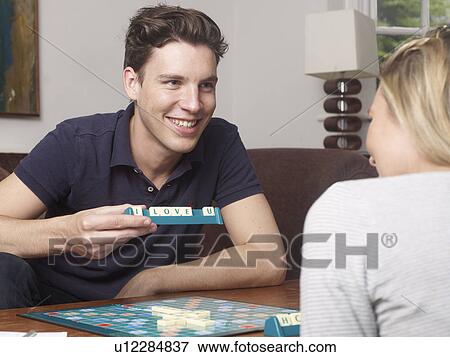Stock Photo - Couple playing scrabble together. Fotosearch