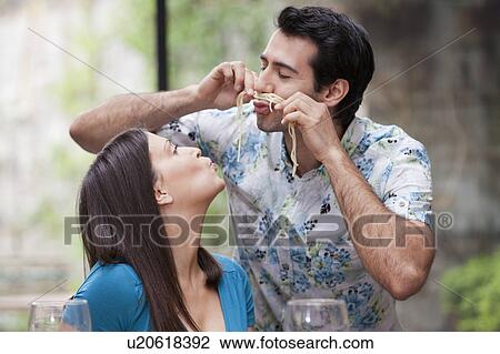 Couple playing with spaghetti at dinner View Large Photo Image Stock Image - Couple playing with spaghetti at dinner. Fotosearch