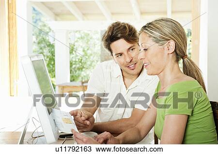 Couple reading bills together View Large Photo Image Stock Image - Couple reading bills together. Fotosearch