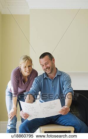 Couple reading instructions in new home View Large Photo Image Stock Photography - Couple reading instructions in new home. Fotosearch