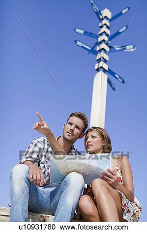 Couple reading map at crossroads View Large Photo Image Stock Image - Couple reading map at crossroads. Fotosearch