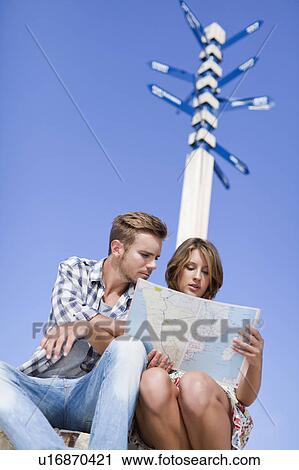 Couple reading map at crossroads View Large Photo Image Stock Image - Couple reading map at crossroads. Fotosearch