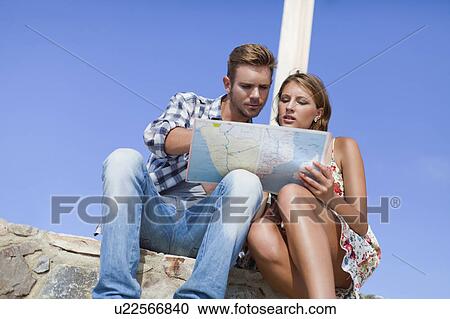 Couple reading map at crossroads View Large Photo Image Stock Image - Couple reading map at crossroads. Fotosearch
