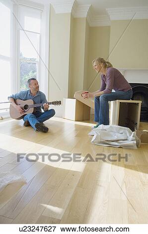 Couple relaxing in new home View Large Photo Image Stock Photo - Couple relaxing in new home. Fotosearch