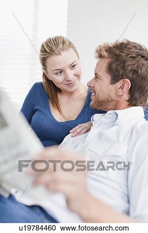 Couple relaxing on couch together View Large Photo Image Stock Image - Couple relaxing on couch together. Fotosearch