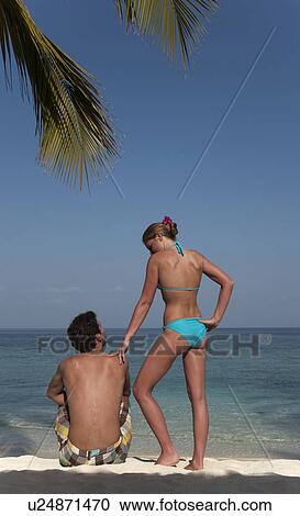 Couple relaxing on tropical beach View Large Photo Image Stock Image - Couple relaxing on tropical beach. Fotosearch