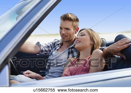 Stock Photography - Couple riding in convertible. Fotosearch