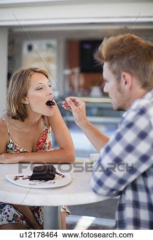 Couple sharing dessert at cafe View Large Photo Image Picture - Couple sharing dessert at cafe. Fotosearch