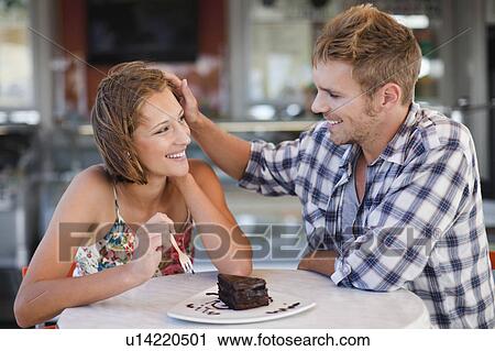 Couple sharing dessert at cafe View Large Photo Image Stock Image - Couple sharing dessert at cafe. Fotosearch