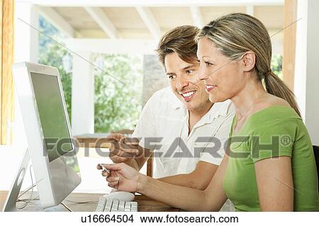 Couple shopping on the internet View Large Photo Image Picture - Couple shopping on the internet. Fotosearch