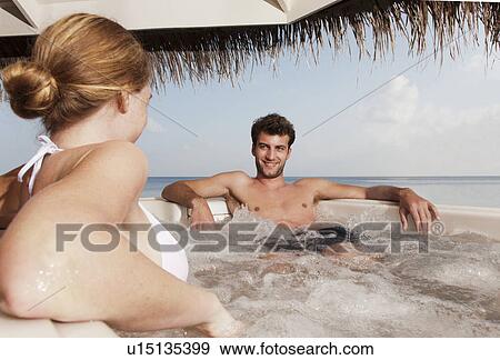 Couple sitting in hot tub View Large Photo Image Stock Photo - Couple sitting in hot tub. Fotosearch
