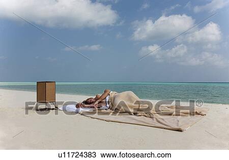Couple sleeping in bed on beach View Large Photo Image Stock Image - Couple sleeping in bed on beach. Fotosearch