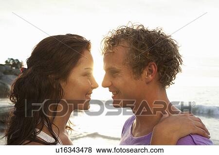 Stock Photo - Couple smiling at each other. Fotosearch