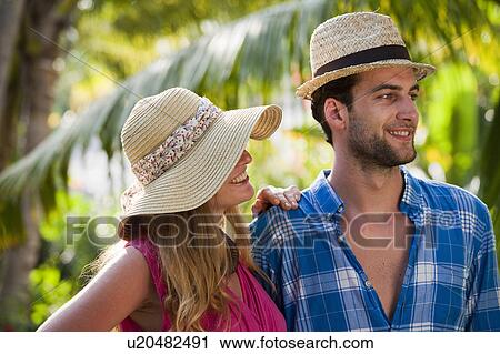 Couple standing in tropical resort View Large Photo Image Stock Image - Couple standing in tropical resort. Fotosearch
