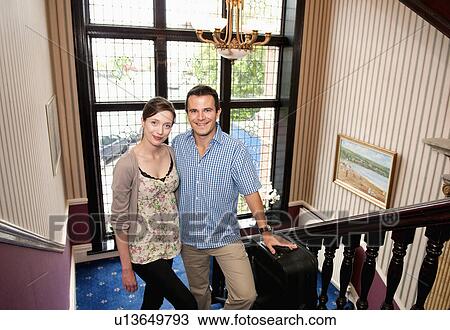 Couple standing on steps in house View Large Photo Image Stock Image - Couple standing on steps in house. Fotosearch