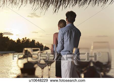 Stock Photo - Couple standing together on dock. Fotosearch