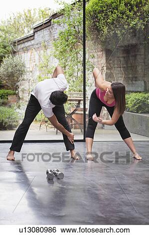 Couple stretching before exercise View Large Photo Image Stock Photograph - Couple stretching before exercise. Fotosearch