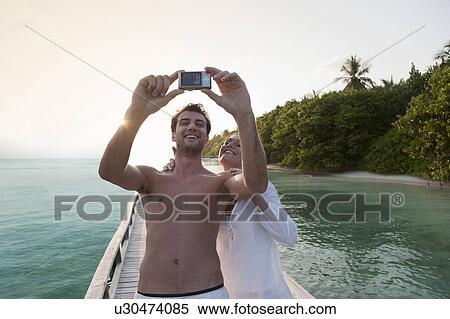 Couple taking picture of themselves View Large Photo Image Stock Photography - Couple taking picture of themselves. Fotosearch