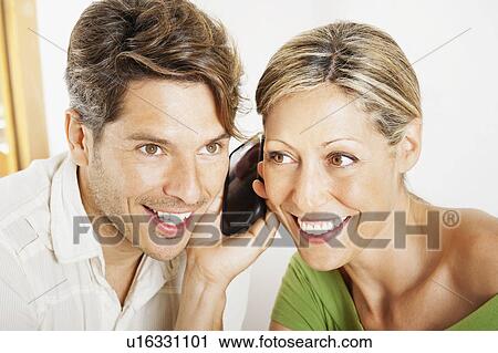 Couple talking on cell phone together View Large Photo Image Stock Image - Couple talking on cell phone together. Fotosearch