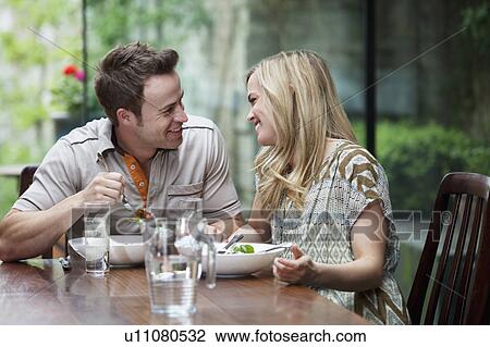 Stock Image - Couple talking over meal at home. Fotosearch