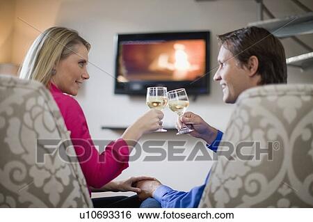 Couple toasting each other View Large Photo Image Stock Photograph - Couple toasting each other. Fotosearch