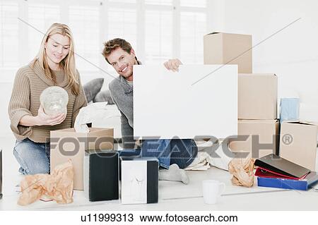 Couple unpacking boxes in new home View Large Photo Image Stock Image - Couple unpacking boxes in new home. Fotosearch