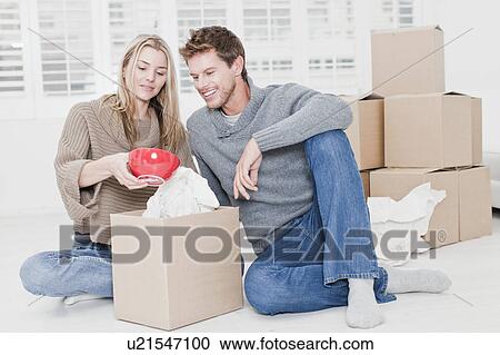 Couple unpacking boxes in new home View Large Photo Image Stock Image - Couple unpacking boxes in new home. Fotosearch