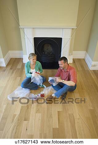 Couple unpacking mugs in new home View Large Photo Image Stock Image - Couple unpacking mugs in new home. Fotosearch