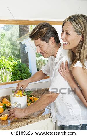 Couple using a juicer in kitchen View Large Photo Image Stock Photography - Couple using a juicer in kitchen. Fotosearch