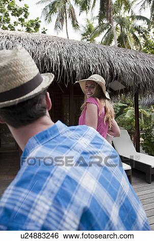 Couple walking in tropical resort View Large Photo Image Stock Photograph - Couple walking in tropical resort. Fotosearch