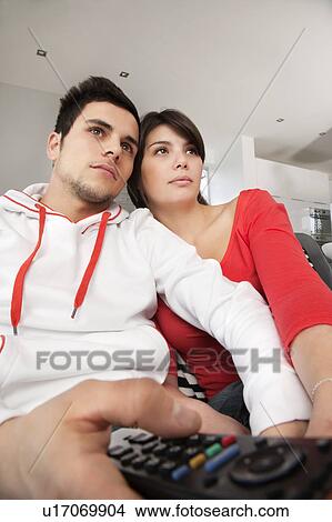 Couple watching television together View Large Photo Image Picture - Couple watching television together. Fotosearch