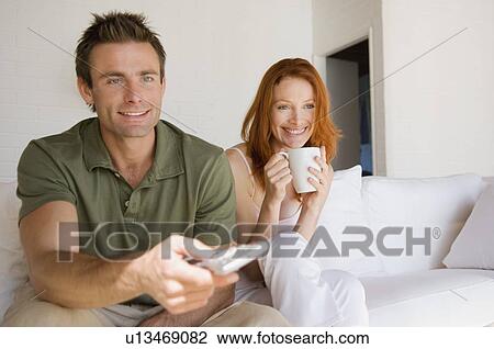 Couple watching television together View Large Photo Image Stock Image - Couple watching television together. Fotosearch