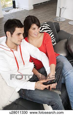 Couple watching television together View Large Photo Image Stock Image - Couple watching television together. Fotosearch