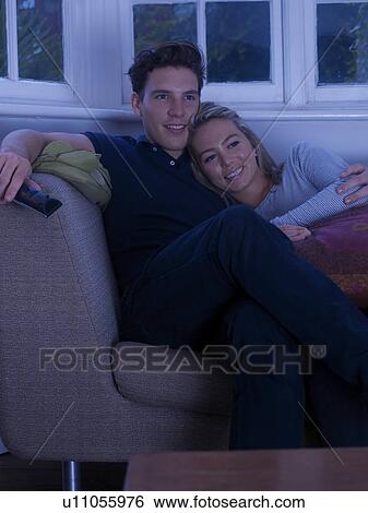 Couple watching television together View Large Photo Image Stock Photograph - Couple watching television together. Fotosearch