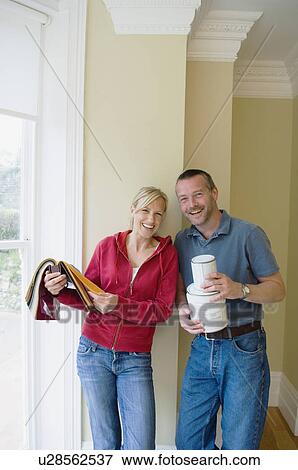Stock Photo - Couple with fabric swatches and paint. Fotosearch