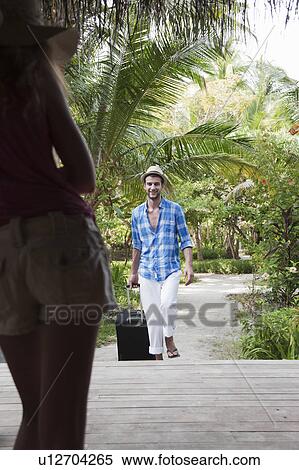 Couple with luggage at tropical resort View Large Photo Image Stock Photography - Couple with luggage at tropical resort. Fotosearch