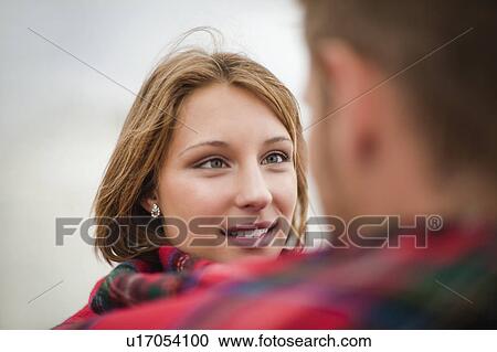 Couple wrapped in blanket together View Large Photo Image Stock Image - Couple wrapped in blanket together. Fotosearch