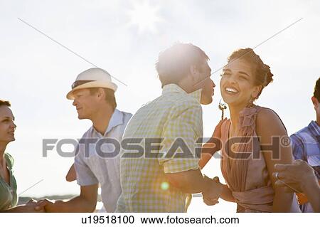 Couples talking on beach View Large Photo Image Stock Image - Couples talking on beach. Fotosearch