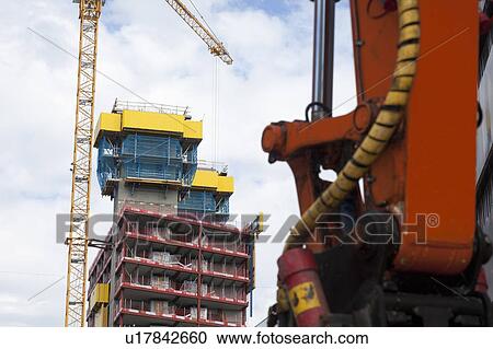 Stock Image - Crane at construction site in city. Fotosearch