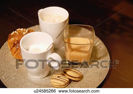 Stock Photograph - Cups of coffee and cookies on tray. Fotosearch