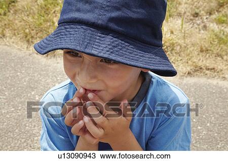 Curious boy touching his mouth View Large Photo Image Stock Image - Curious boy touching his mouth. Fotosearch