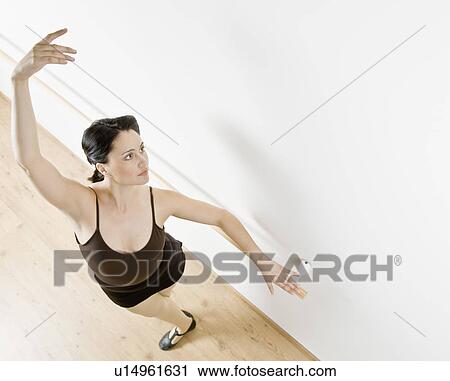 Dancer posing at barre in studio View Large Photo Image Stock Image - Dancer posing at barre in studio. Fotosearch