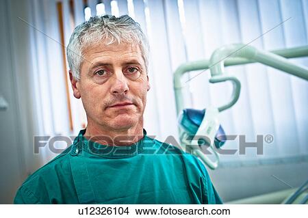 Picture - Dentist sitting in office. Fotosearch