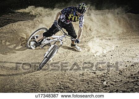Dirt biker riding on path View Large Photo Image Stock Photo - Dirt biker riding on path. Fotosearch