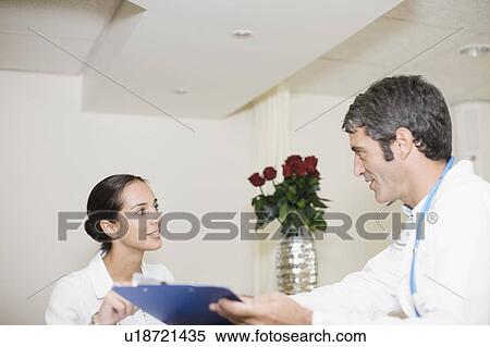 Doctor and nurse talking in hospital View Large Photo Image Stock Photography - Doctor and nurse talking in hospital. Fotosearch
