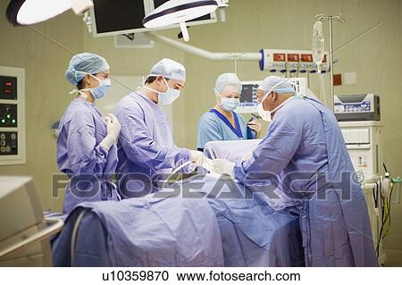 Doctor and nurses performing operation View Large Photo Image Stock Image - Doctor and nurses performing operation. Fotosearch