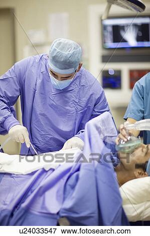 Stock Photo - Doctor performing operation. Fotosearch