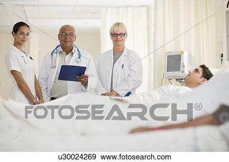 Doctors and nurse in hospital room View Large Photo Image Stock Photo - Doctors and nurse in hospital room. Fotosearch