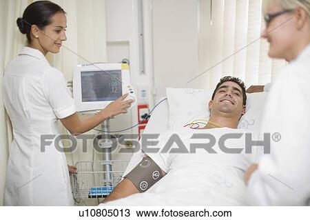 Doctors and nurse tending to patient View Large Photo Image Stock Image - Doctors and nurse tending to patient. Fotosearch